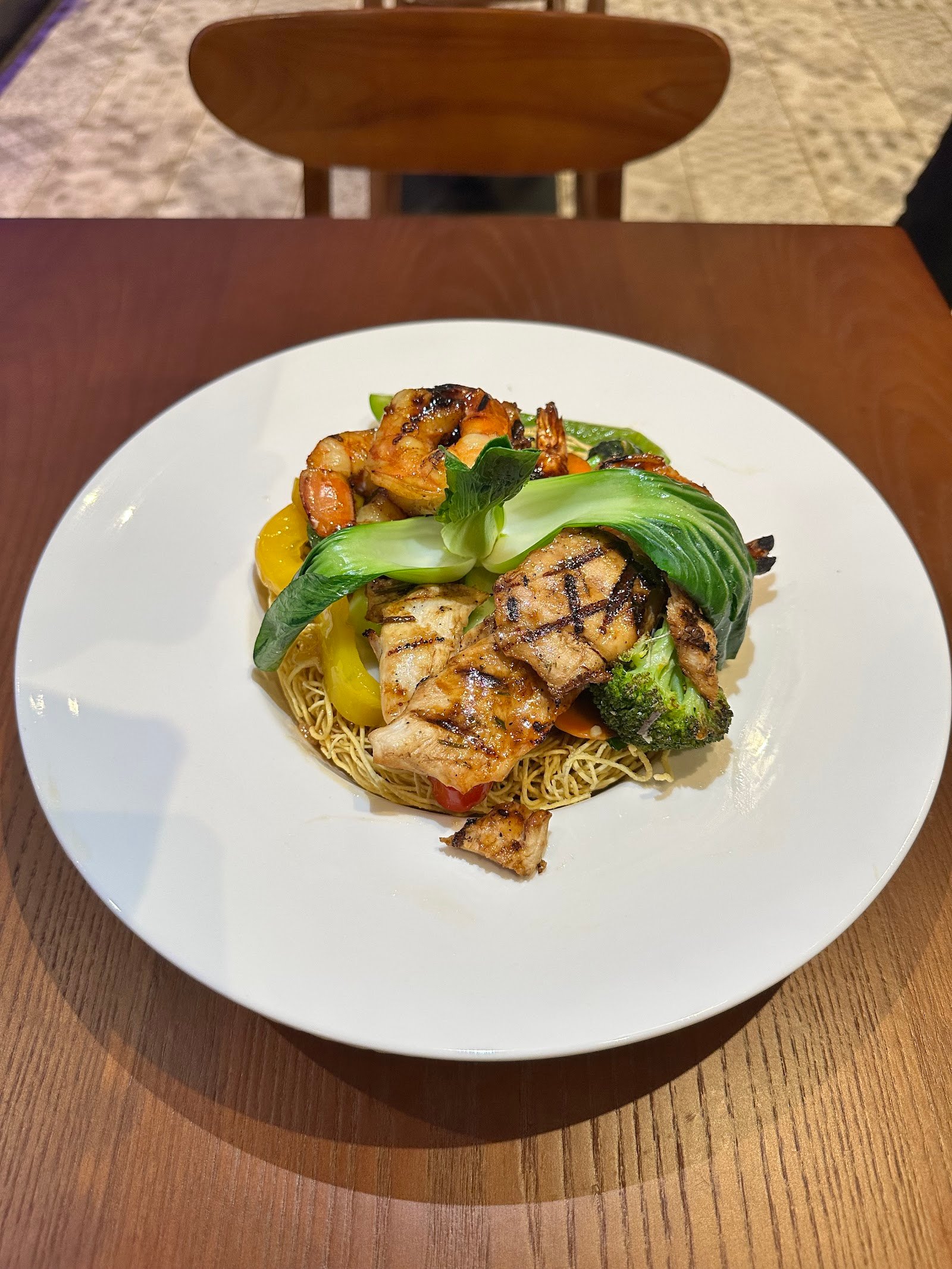 Crispy noodle at Pho Maison Aruba — golden fried egg noodles topped with grilled chicken, shrimp and bok choy