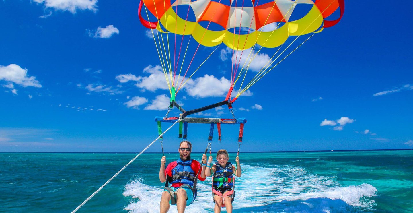 Guests parasailing on a Skyview Watersports flight over the Caribbean in Aruba