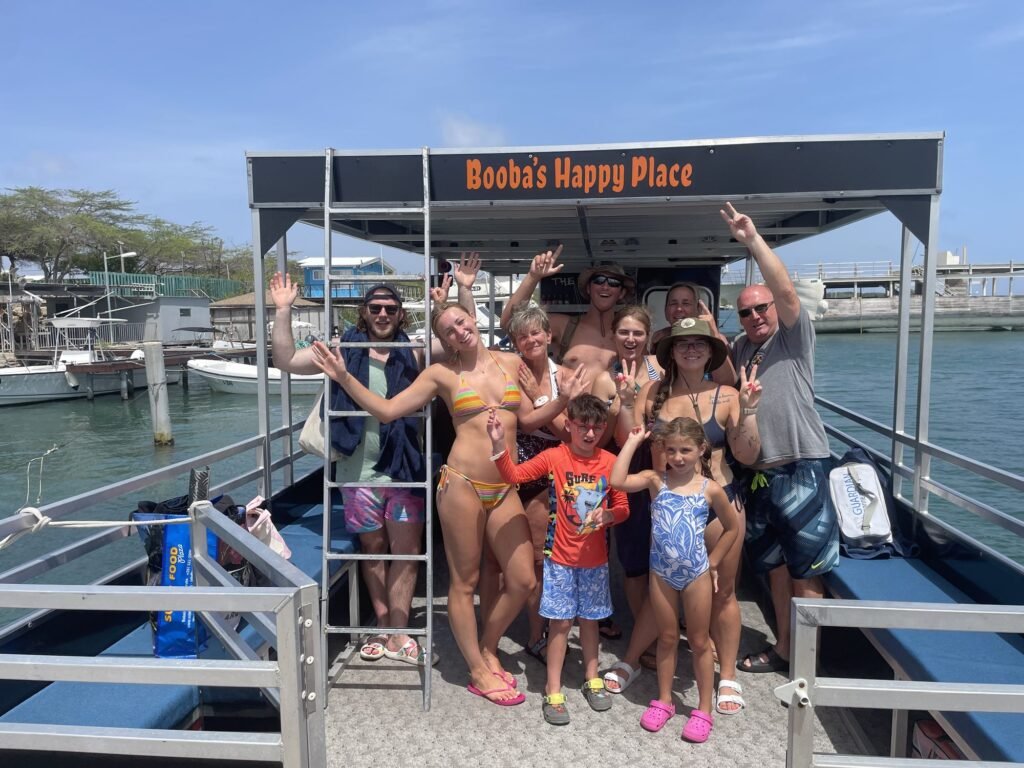 Guests on the deck of the Booba's Pontoon Tours pontoon boat in Aruba before a private charter