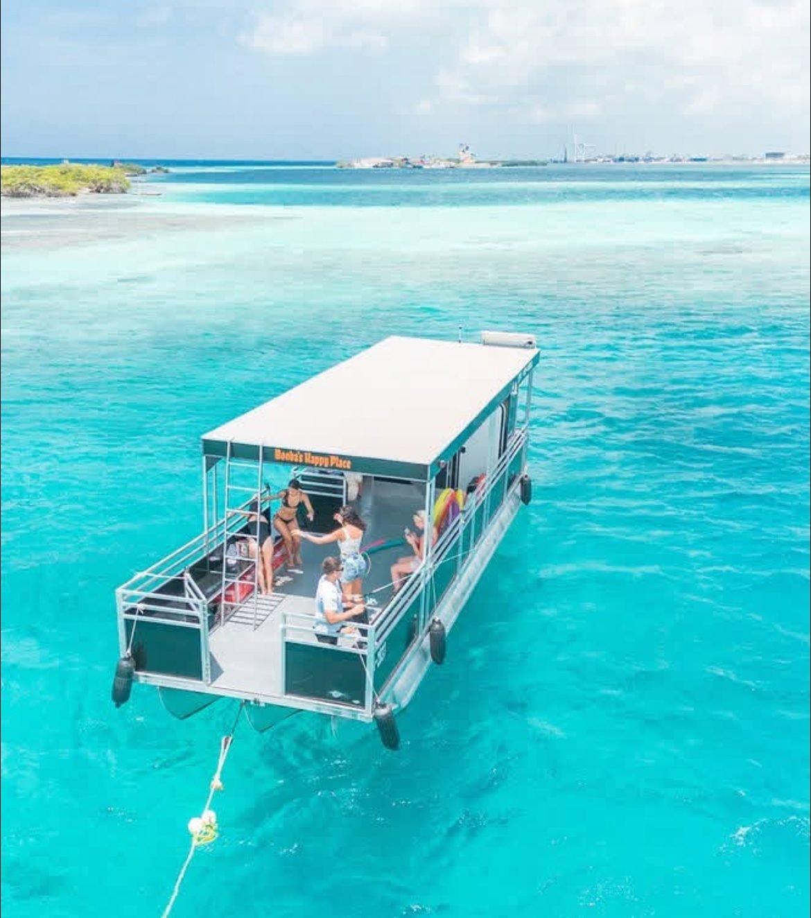 The Booba’s Pontoon Tours pontoon boat anchored in clear water during an Aruba charter