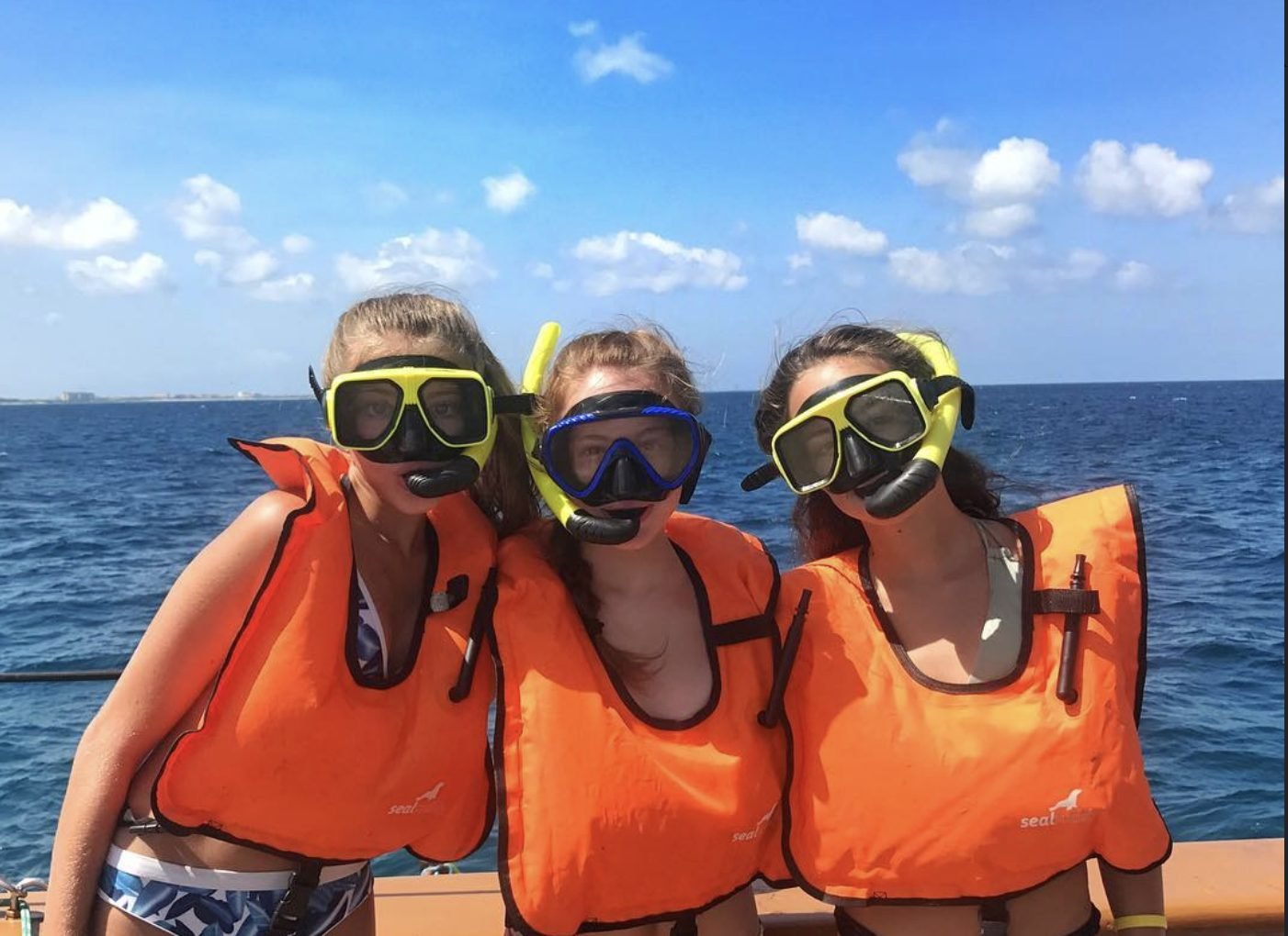 Guests in snorkel masks and life vests before a snorkel stop