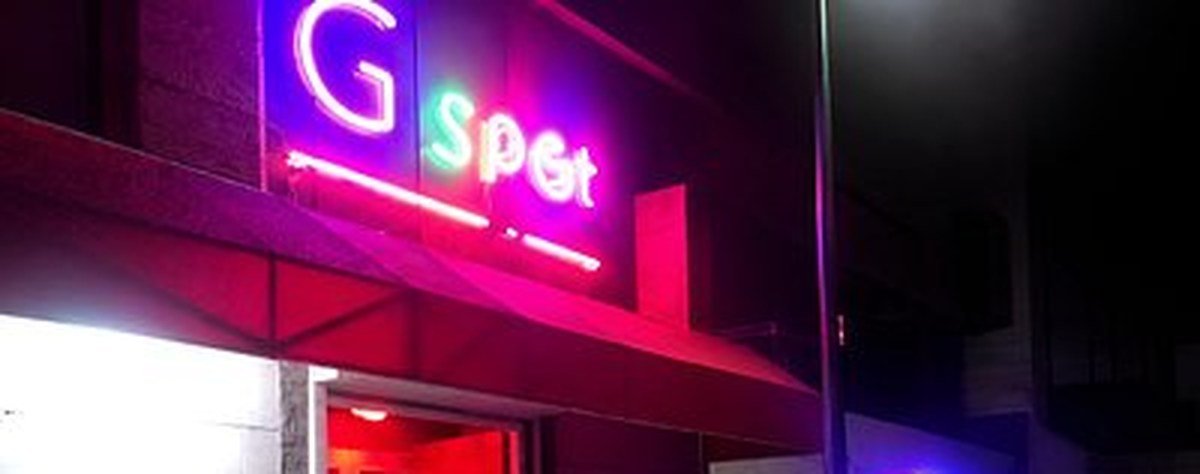 Neon lights outside a bar in the San Nicolas nightlife strip after dark