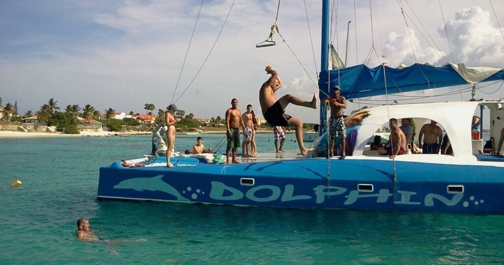 Dolphin catamaran anchored for a private snorkel charter in Aruba