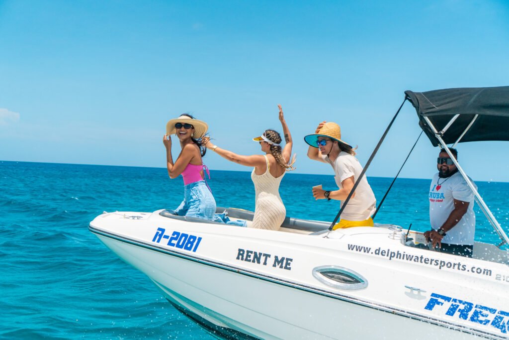 Guests on a private boat ride in turquoise Aruba water
