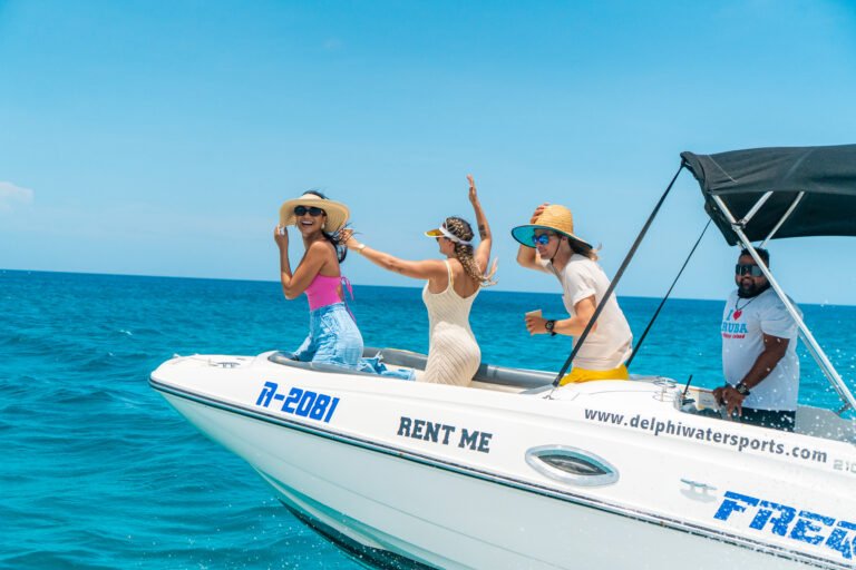 Guests on a private boat ride in turquoise Aruba water