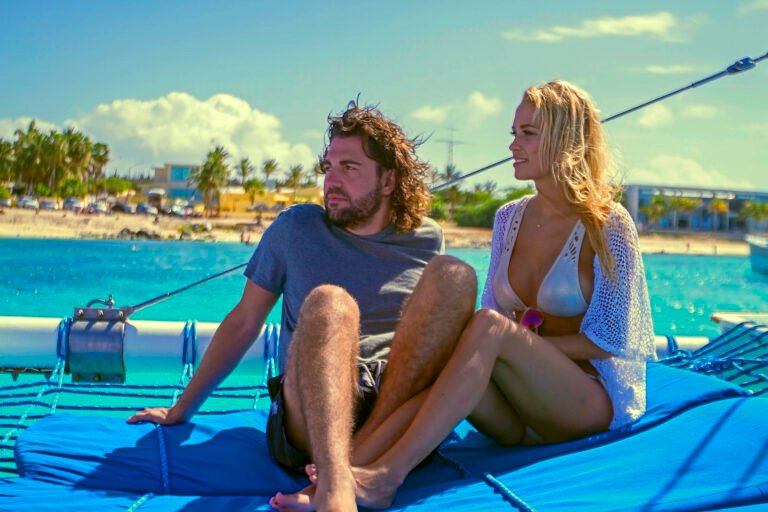 Couple relaxing on the deck of a private catamaran in Aruba
