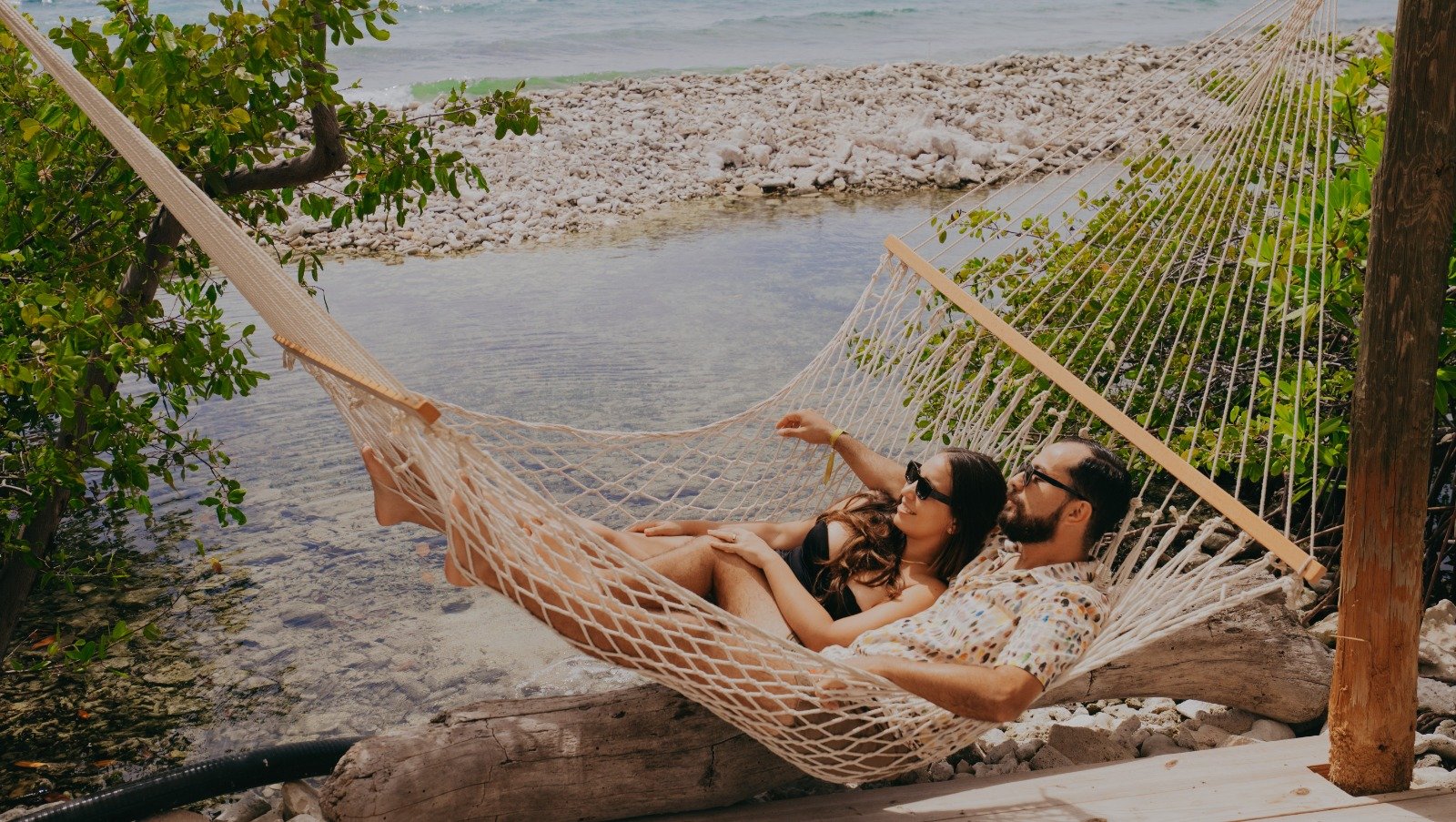 Couple relaxing in a hammock on a private island in Aruba