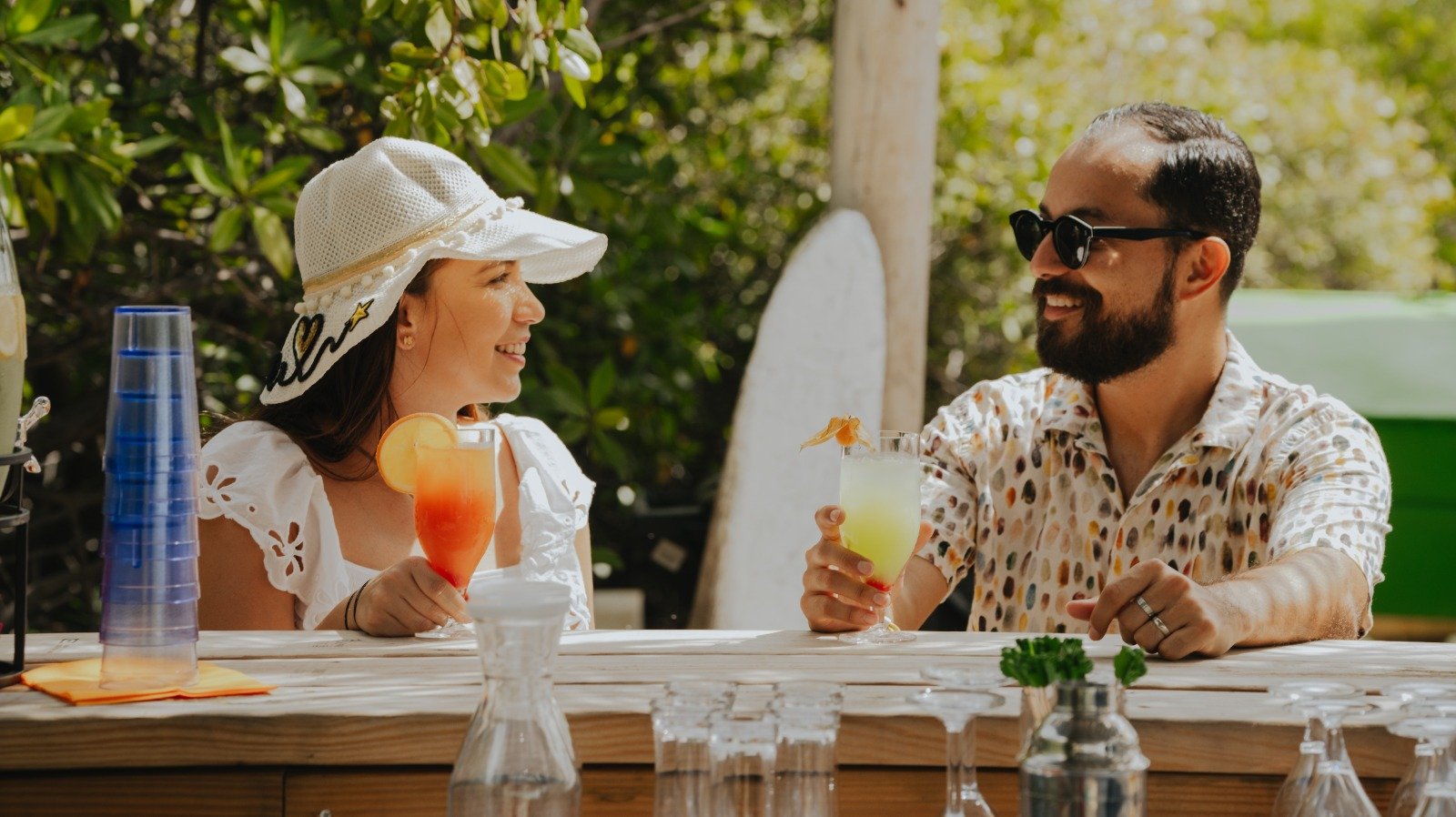 Guests with tropical drinks at the island bar on a private island escape in Aruba