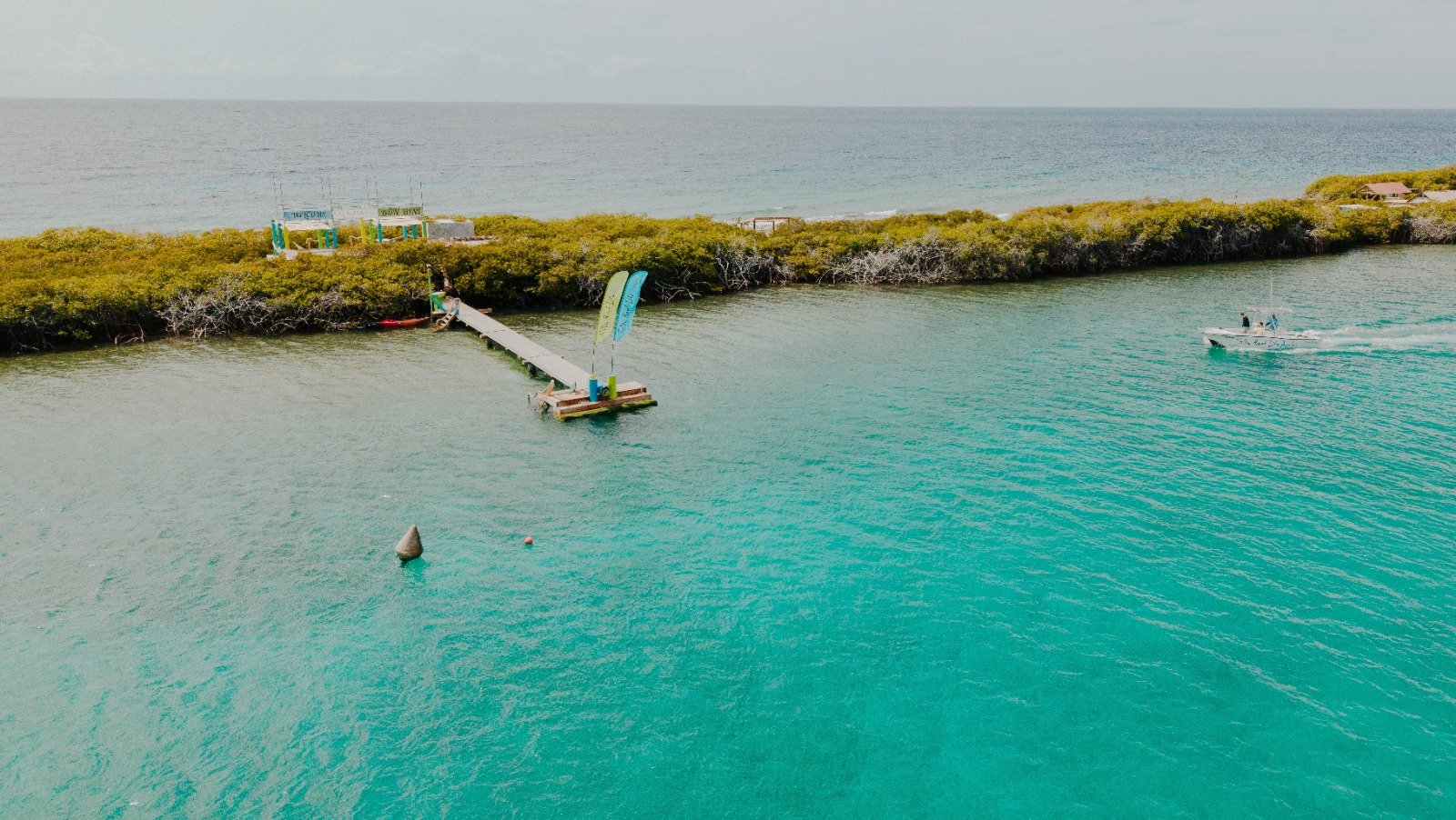Private island Aruba seen from above with its pier in turquoise water