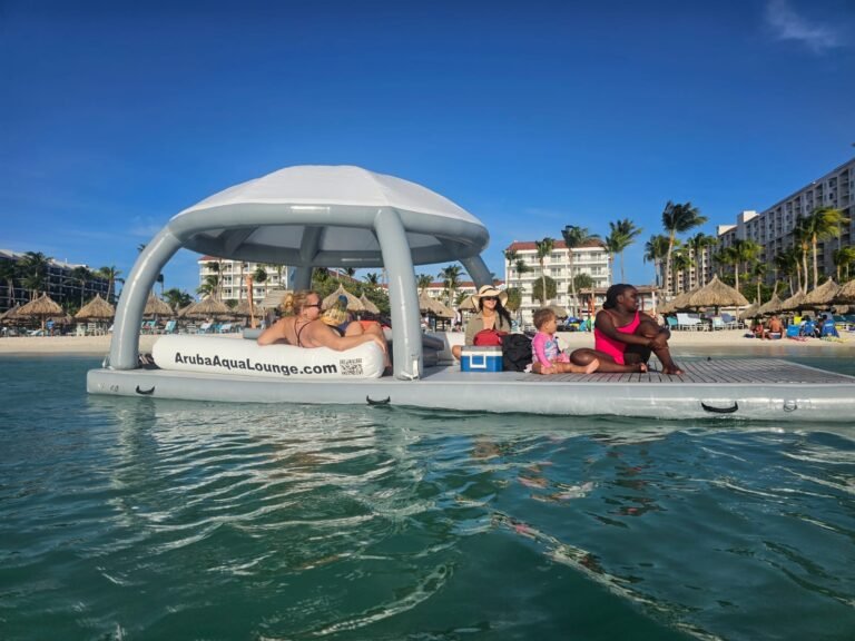Guests relaxing on the Bonanza Lounge sundeck and under the canopy, beach hotels behind